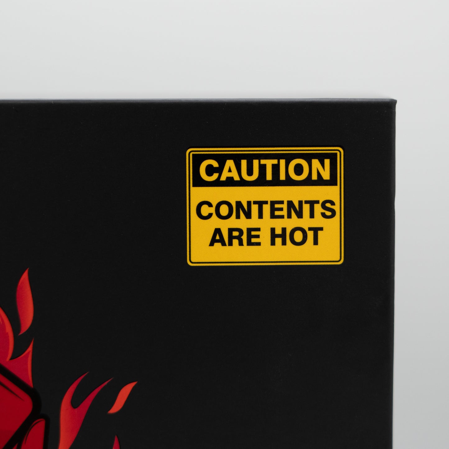 Close-up of the yellow “Caution Contents Are Hot” label on the Hot Hands Sports Cards box