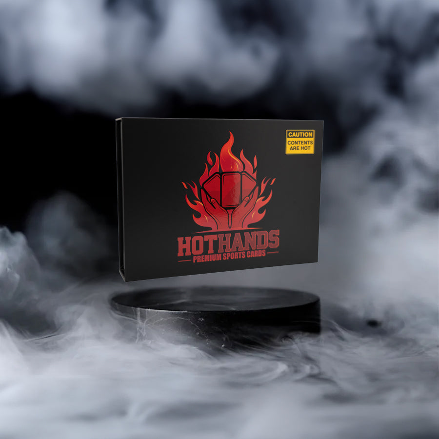 Hot Hands Sports Cards Box on Smoky Background - A sleek black box with the Hot Hands Sports logo, featuring a flaming sports card icon, sits on a dark, smoky platform. The box includes a caution label reading ‘Contents Are Hot,’ emphasizing the high-quality, exclusive sports cards inside. Perfect for collectors seeking rare and premium card experiences.
