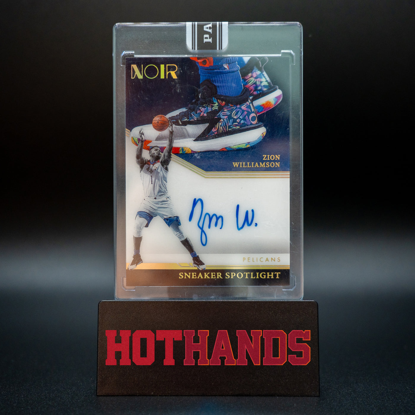 Zion Williamson Panini Noir Black Box 1/1 Sneaker Spotlight autographed card displayed on a Hot Hands stand.