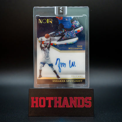Zion Williamson Panini Noir Black Box 1/1 Sneaker Spotlight autographed card displayed on a Hot Hands stand.